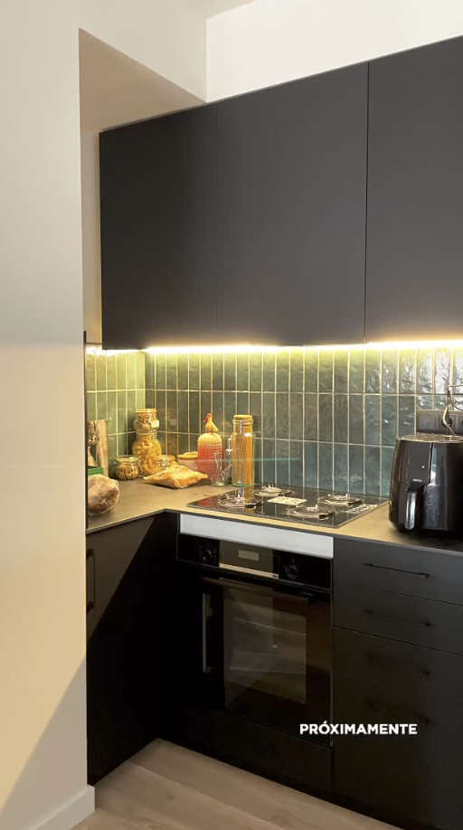 Frontal de cocina moderna con azulejo cerámico verde e iluminación bajo mueble en Sant Andreu Barcelona